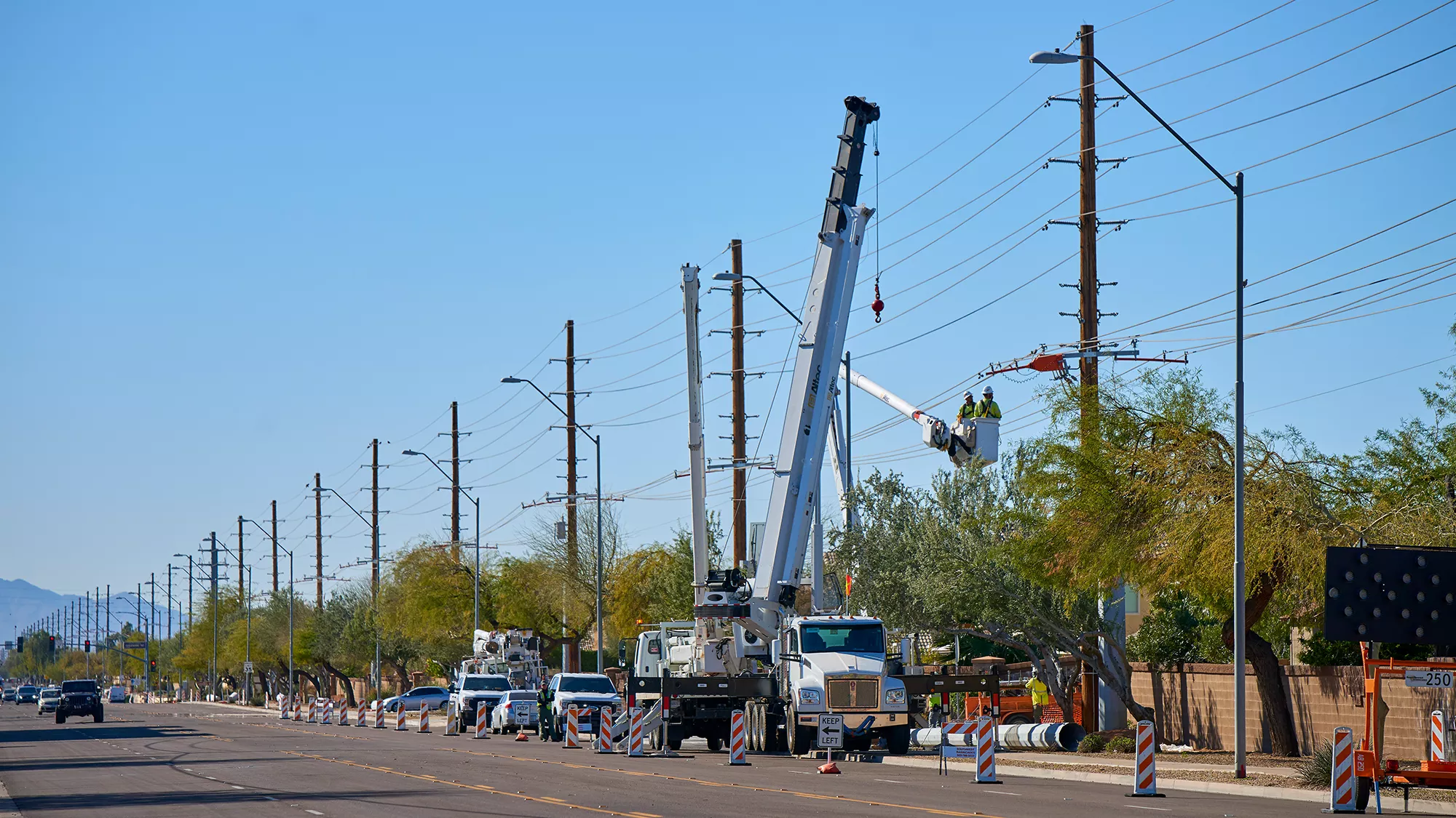 National Powerline team working on powerlines with cranes.