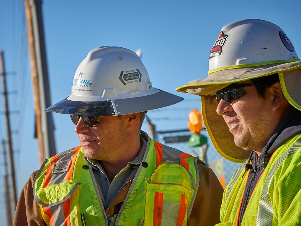 Two National Powerline supervisors standing close to each other.